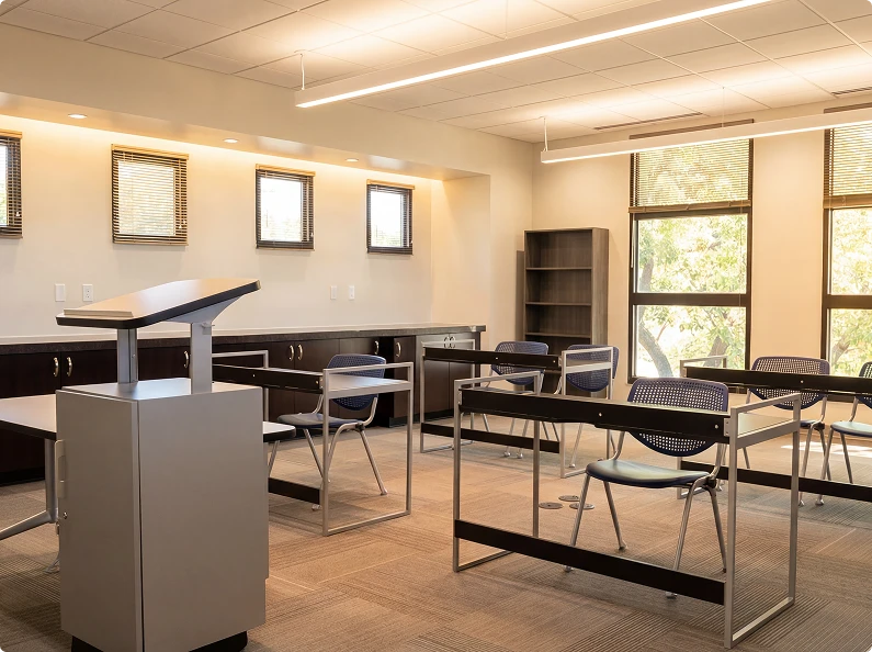 Classroom-style training space with podium, desks, and large windows