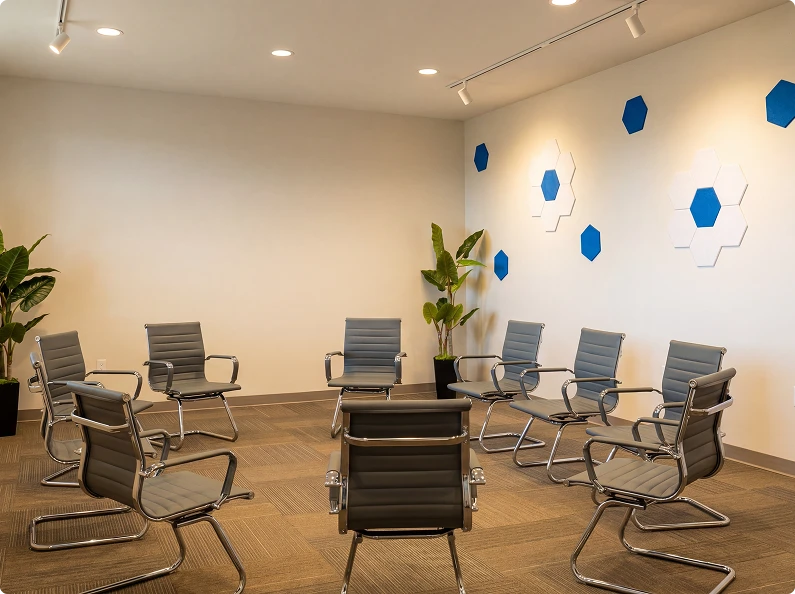 Peer support meeting space with movable chairs and open floor layout