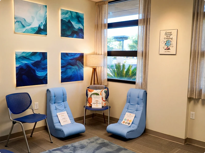 Quiet reflection corner with lounge chairs, artwork, and natural light