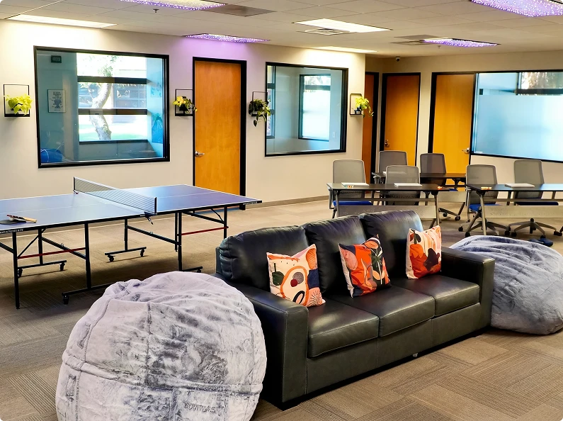 Recreation lounge with ping pong table, bean bag seating, and gathering space